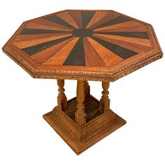 an octagonal wooden table with black and brown stripes on it's top, in the shape of a sunburst