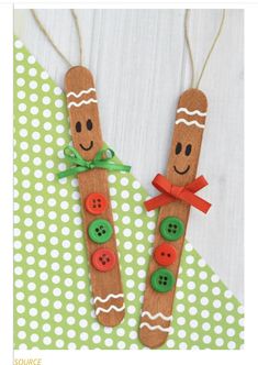 two wooden sticks decorated with buttons and smiling faces