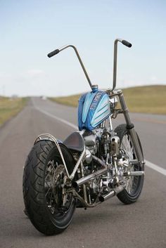 a blue motorcycle is parked on the side of the road