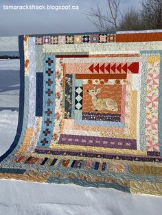 a quilted wall hanging in the snow