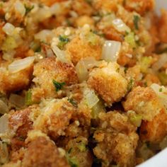 a white bowl filled with stuffing and vegetables