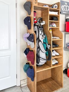 a wooden shelf filled with lots of hats and other sports equipment on top of it