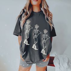 F L O R A   M I R A  D E S I G N S  Model in the photo sized up to XL to achieve the oversized look, these are printed on the most loved comfort colors tee :) ★ Get your skelly vibes flowing with this trendy western themed t-shirt! Designed by me here at FloraMira, the retro skeleton aesthetic is a must have. Perfect for a cowgirl disco bachelorette, gift for your bestie, or yourself! ★  Though these shirts are a roomier fit, sizing up 1-2 sizes gives you that true 'oversized' look if that's what you're going for.   you like your shirts more form fitting, I recommend sizing down. The size chart is there to help you, but please message me if you have any questions! 100% Cotton. ★  Printed apparel can be machine-washed cold, INSIDE OUT on a gentle cycle with a mild detergent and like colors Trendy Oversized Skull Print Tops, Trendy Oversized Tops With Skull Print, Casual Long Sleeve T-shirt With Skull Print, Edgy Skull Print Short Sleeve Top, Edgy Short Sleeve Top With Skull Print, Oversized Summer Tops With Character Print, Oversized Skull Print T-shirt For Fall, Skull Print Tops For Spring Streetwear, Trendy Spring Skull Print Top