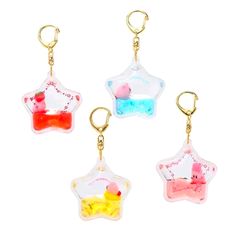 three keychains with different designs on them, one in the shape of a star