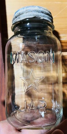 a mason jar with the word mason jar written on it and a star in the bottom