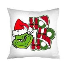 a white pillow with the grin face and santa hat on it's head, which says happy holidays