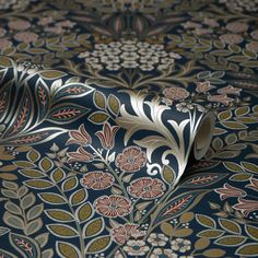 an intricately designed wallpaper with gold and blue flowers on it's surface