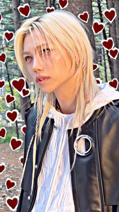 a woman with blonde hair wearing a black leather jacket and red hearts in the background