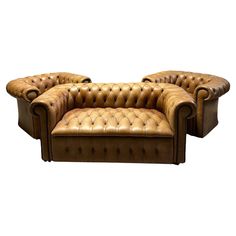 a brown leather couch sitting on top of a white floor