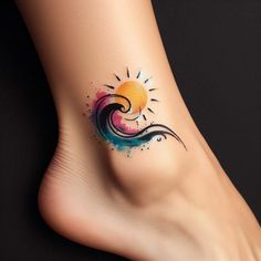 a tattoo on the foot of a woman with sun and wave designs painted on it