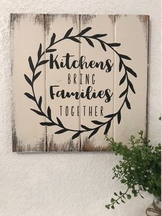 a wooden sign that says kitchen, bring families together on the side of a wall