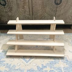 a white shelf sitting on top of a blue rug