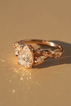 a close up of a diamond ring on a gold surface with sunlight shining through it