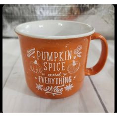 a pumpkin spice and everything is nice coffee mug on a white table with the words pumpkin spice and everything is nice