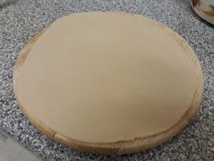 an uncooked pizza sitting on top of a counter