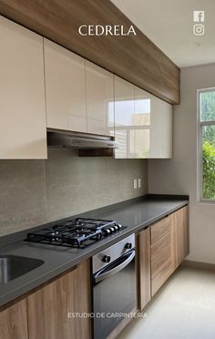 an empty kitchen with wood cabinets and black counter tops is seen in this image from the front view