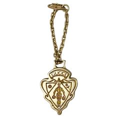 The 1960s Gucci Metal Logo Pendant Keyring brings a timeless elegance to any look. Crafted with high-quality gold-tone brass, it features a classic chain and buckle clutch for lasting durability. The signature Gucci logo emblem adds sophistication. Elevate your look with this premium keyring. Condition: vintage, 1980s, overall good, shows some sign of color fading Dimensions: 4x3.5x05cm - 10cm long including chain Elegant Gold Jewelry With Logo Plaque, Vintage Gucci Jewelry For Formal Events, Formal Gold Jewelry With Metal Logo, Vintage Gucci Jewelry For Formal Occasions, Gucci Gold Jewelry With Logo Charm, Elegant Gucci Necklace With Logo Charm, Vintage Gucci Gold Jewelry, Vintage Gold-tone Jewelry With Logo Charm, Gucci Logo