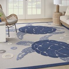 a living room with a blue turtle rug on the floor