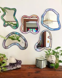 a wooden table topped with mirrors and plants