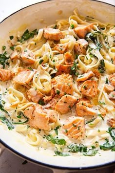 pasta with salmon and spinach in a skillet