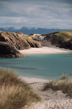 the water is very blue and clear in this area with sand dunes on both sides