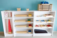 a white book shelf filled with lots of different types of wooden blocks and building blocks