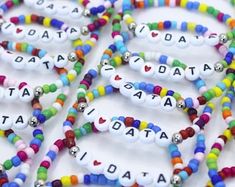 several bracelets with different colored beads and letters that spell out the word, i love dad