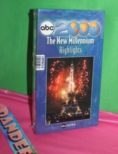 the new millennium highlights dvd is sitting on top of a pink tablecloth with a green background