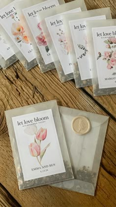 five packets of let love bloom tea sitting on a wooden table next to a wax seal