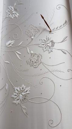 an artistically designed wallpaper is shown with a pen on top of the paper