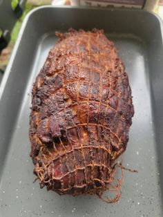 a large piece of meat sitting on top of a pan