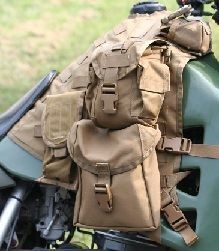 a close up of a motorcycle with some bags on it's back pack attached to the handlebars