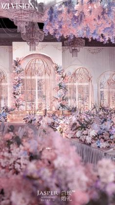 a room filled with lots of flowers and chandeliers