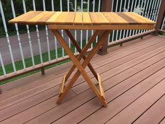 a wooden table sitting on top of a wooden deck