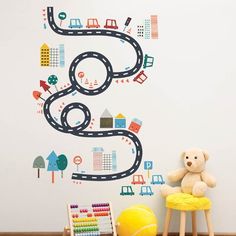 a child's room with a wall decal that has a toy car on it