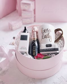 a pink gift box with personal care items in it on a white lace tablecloth