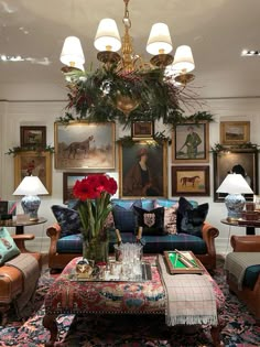 a living room filled with furniture and paintings on the wall above it's coffee table