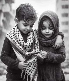 two children standing in the rain with scarves on