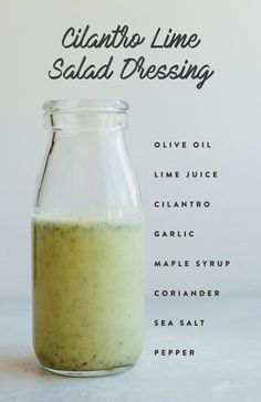 a glass jar filled with liquid sitting on top of a table next to a white wall