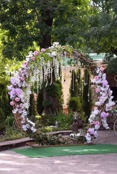 an outdoor wedding ceremony with flowers and greenery on the ground, surrounded by trees