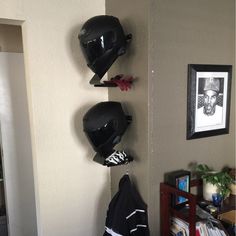 three helmets are hanging on the wall