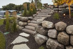 there is a stone wall and steps in the yard