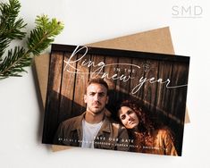 a card with an image of two people on it and the words ring in the new year