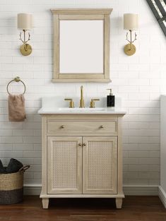 a bathroom vanity with a mirror above it and two lights on the wall next to it