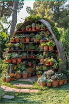 a garden filled with lots of potted plants next to a wooden structure in the grass