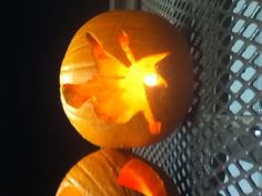 two carved pumpkins sitting on top of a table