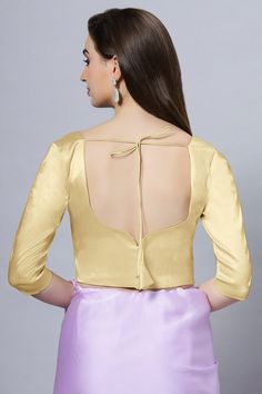 Our Satin Comfort Stretch collection blouses are made to impress and made to be worn all day. Made from the finest satin-cotton blend stretchable fabric, it holds its shape and shine while offering the comfort of stretchable material. Wear it with your favorite saree, as a crop top or lehenga choli! Item Type: Saree blouse / Crop top Product Features: Color: Gold Fabric: Satin Stretch Trim: Back Dori Neck Style: Leaf, Front & Back Sleeve Length: Elbow Sleeve Closure: Back Hook Padded: No Occasio Fitted Party Blouse In Solid Color, Fitted Gold Padded Blouse, Elegant Padded Stretch Blouse, Elegant Stretch Padded Blouse, Elegant Stretch Gold Top, Elegant Gold Stretch Top, Fitted Gold Satin Top, Fitted Long Sleeve Satin Blouse, Elegant Satin Blouse Piece With Padded Blouse