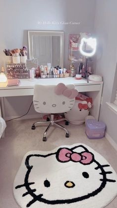 a hello kitty rug sits on the floor in front of a desk with a mirror