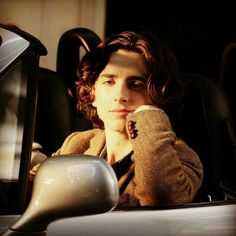 a woman sitting in the passenger seat of a car