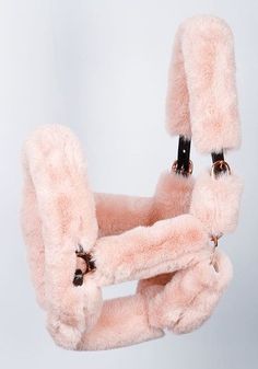 a pink furry chair hanging from the ceiling